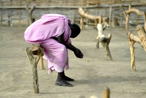 Woman prays while displaced by conflict in contested border region of Sudan